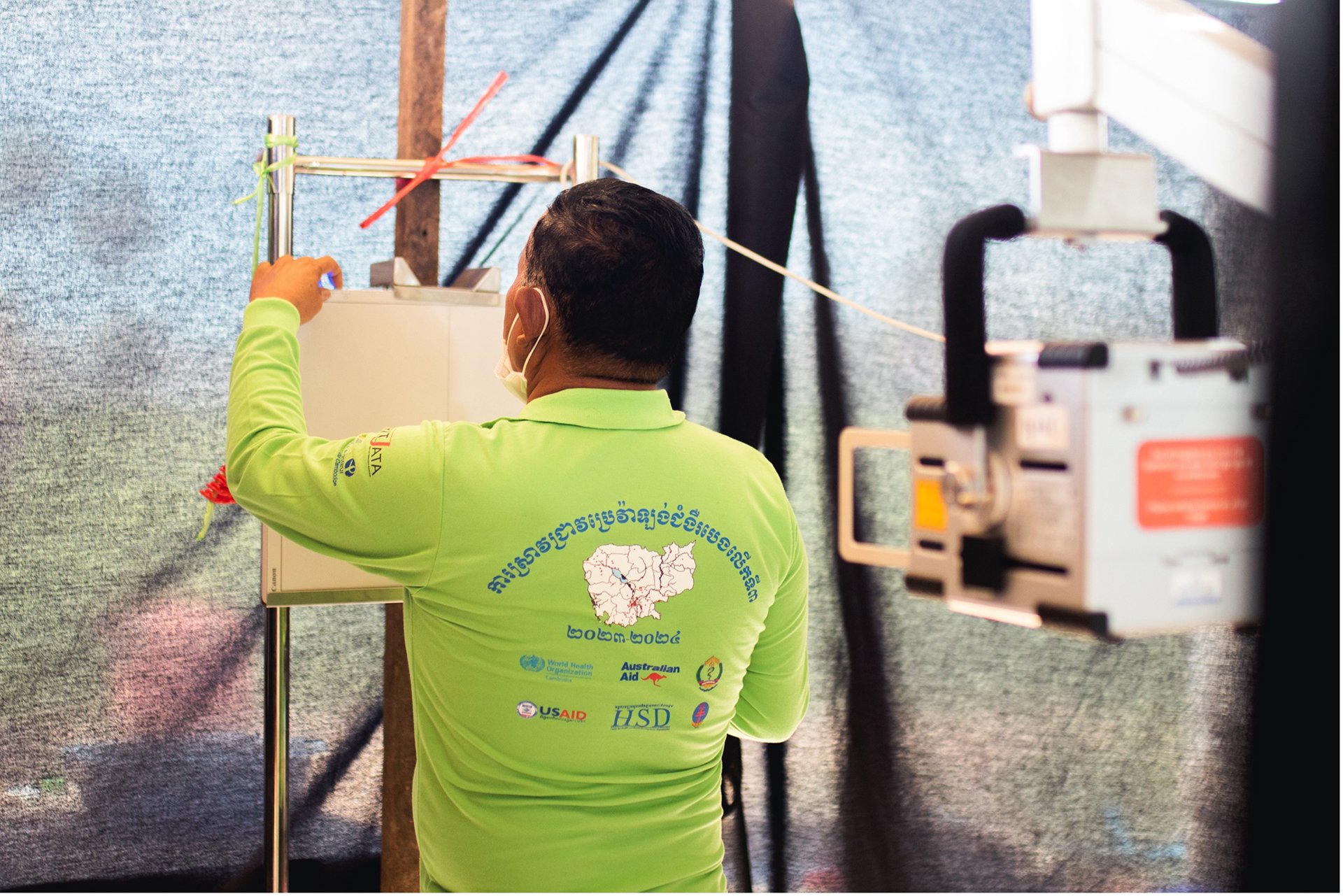 A health worker sets up the chest X-ray machine